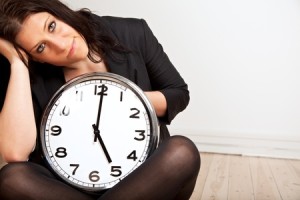 WomanSittingHoldingClock